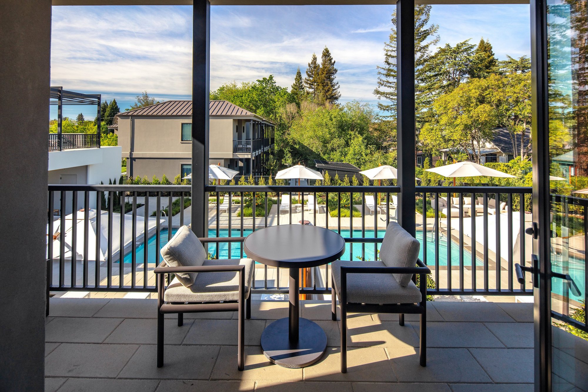 Poolside Upper Level Suite private balcony overlooking the pool courtyard