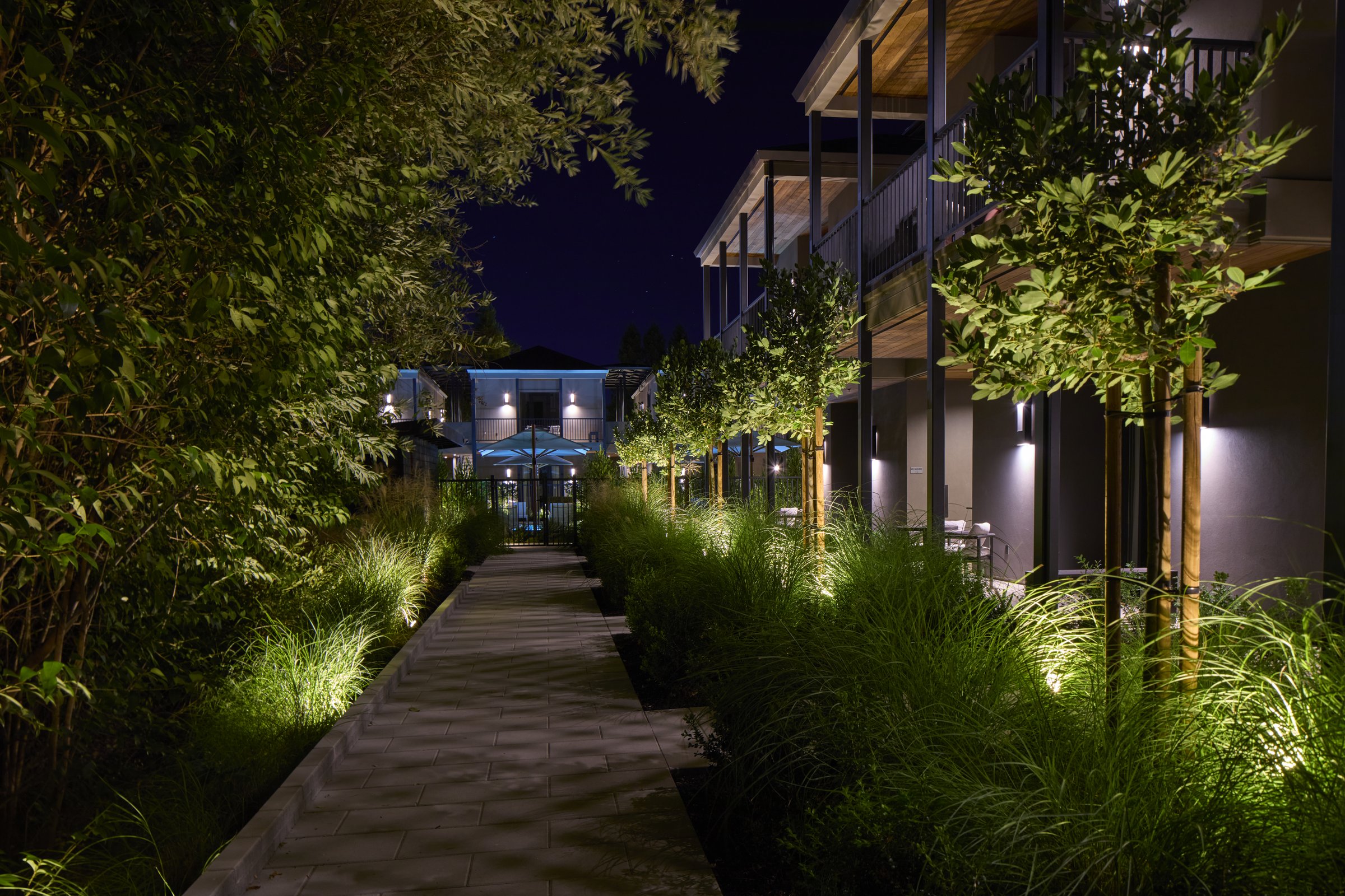 The walkway past the Creekside Suites toward the pool at night.