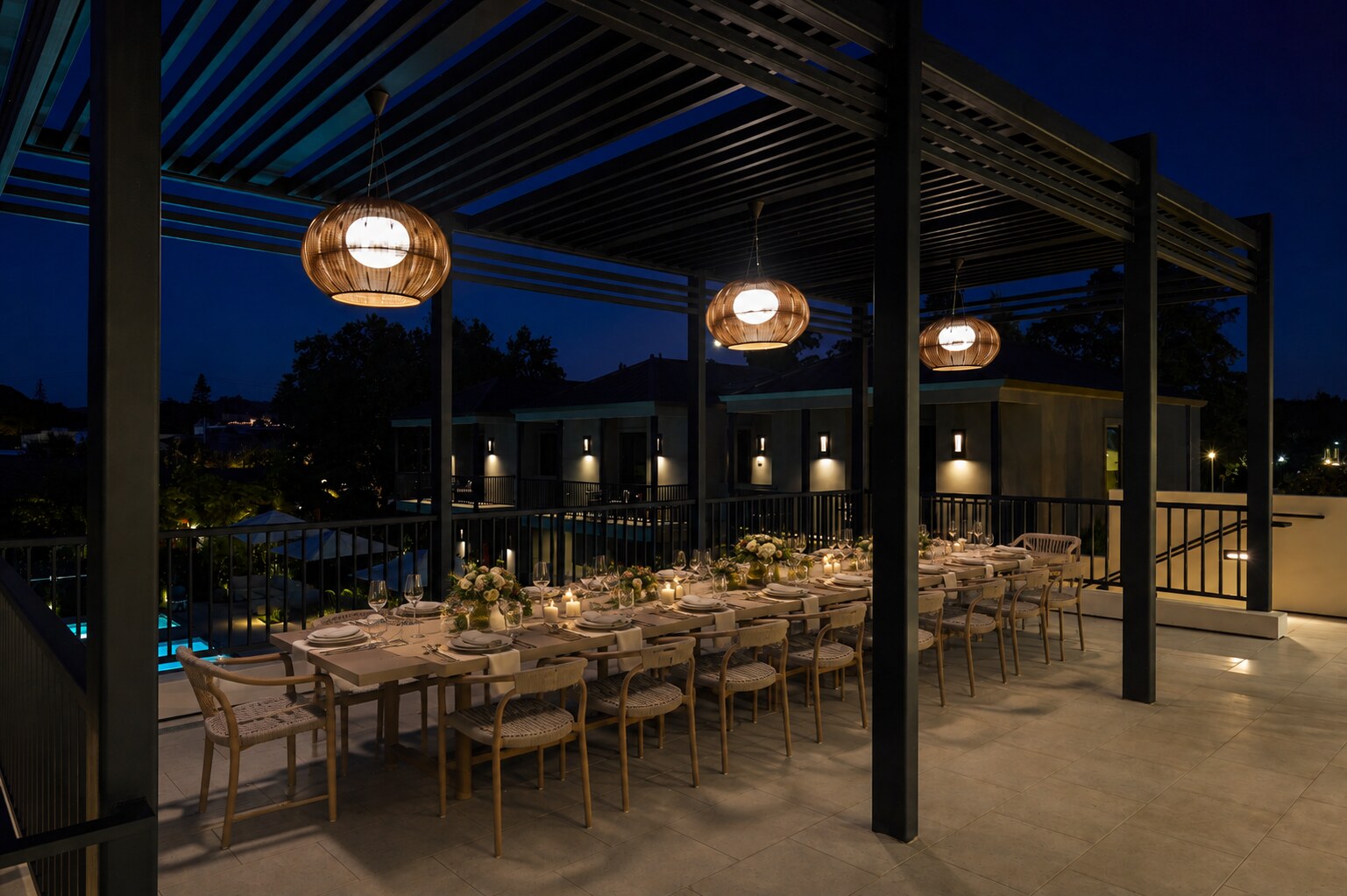 The Duchamp King's Table set for dinner on the rooftop event deck at night.