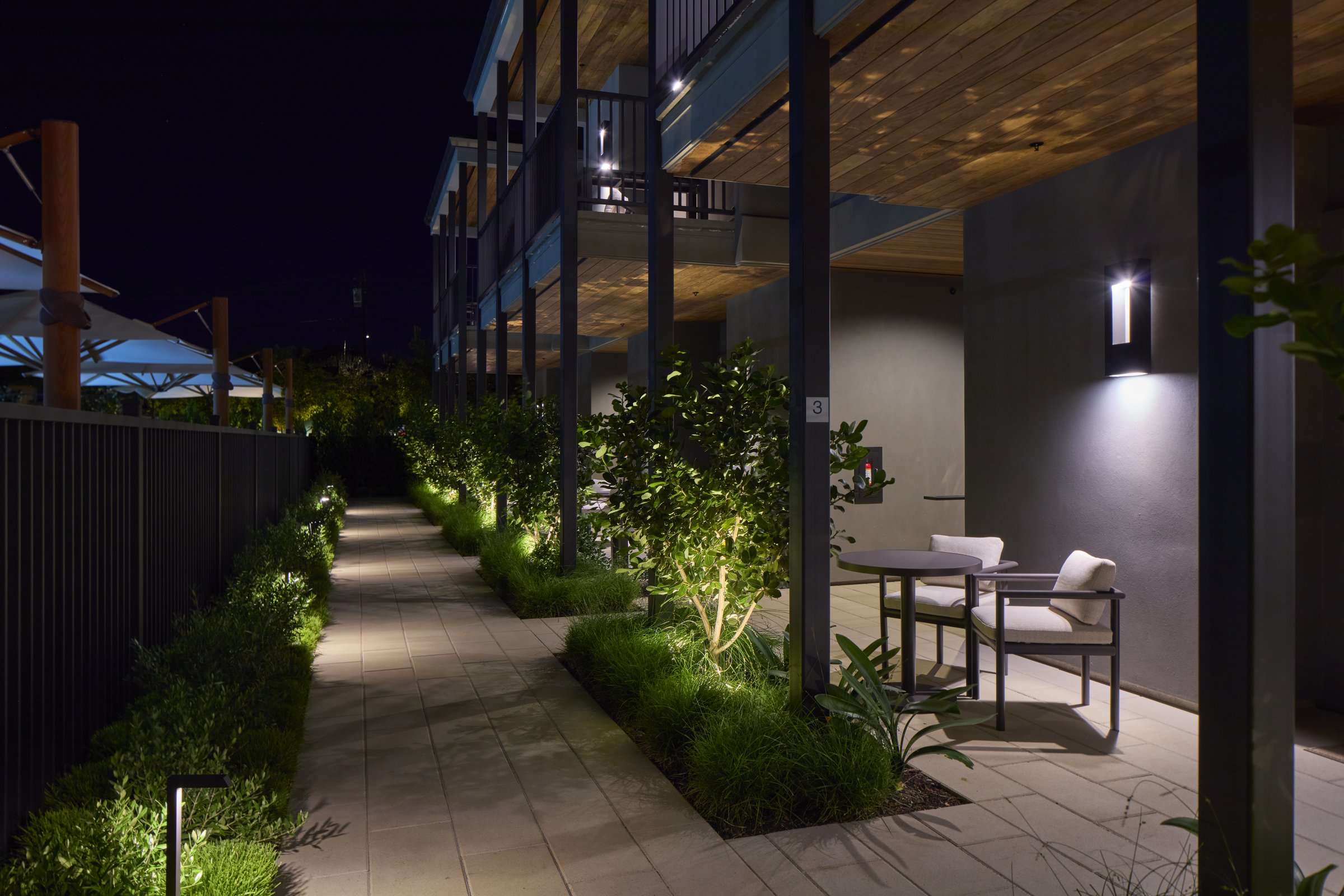 The walkway to the Poolside Suites at night.