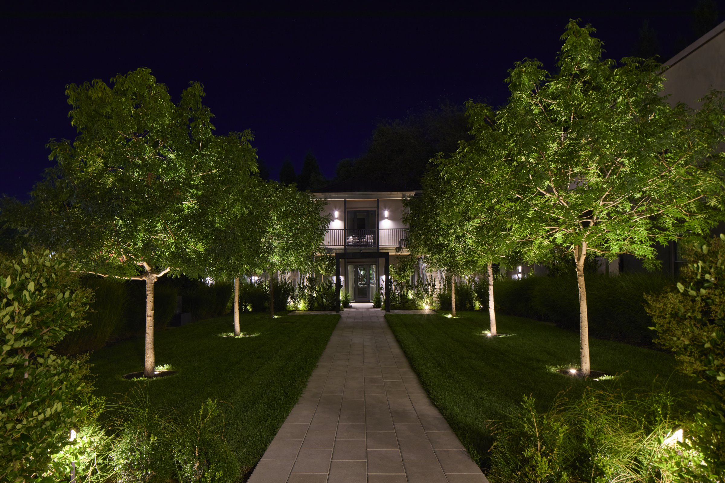 The Grove lawn and garden path at night.