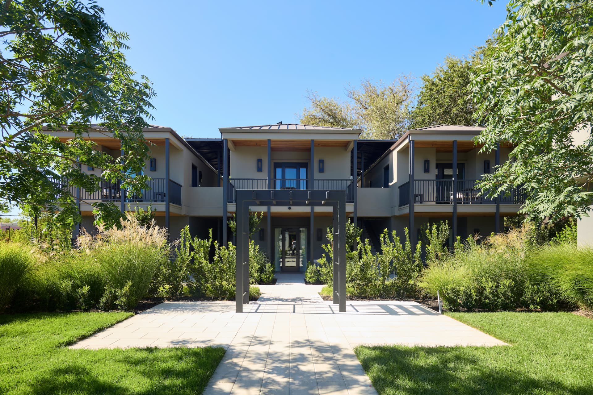 The Grove Suites building beyond the pergola and garden path at Duchamp Healdsburg.
